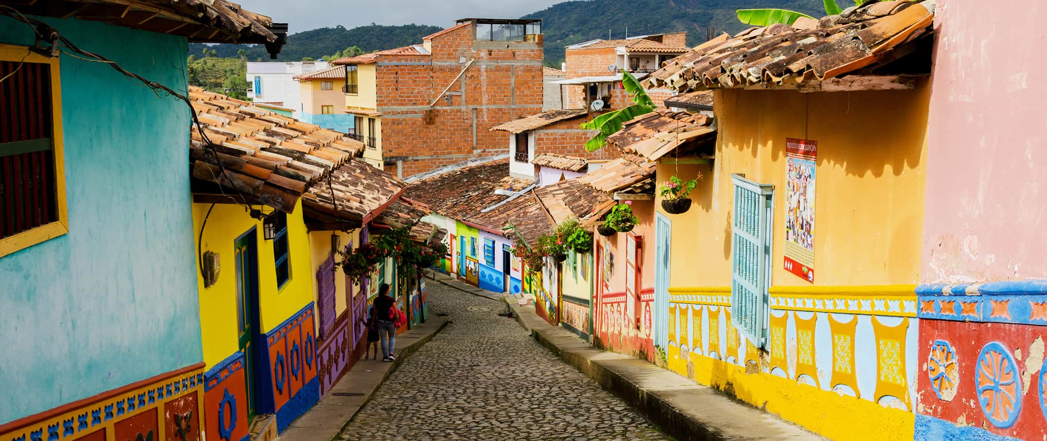 a colorful alleyway looking down a hill in Bogota, Colombia