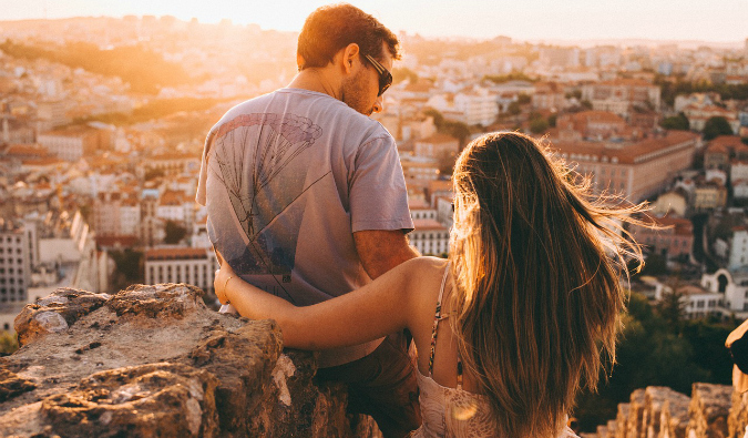 a couple in front of a city landscape