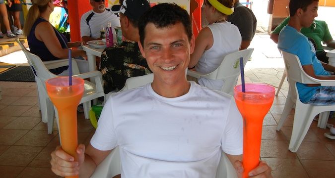 Nomadic Matt holding drinks and enjoying cruise life