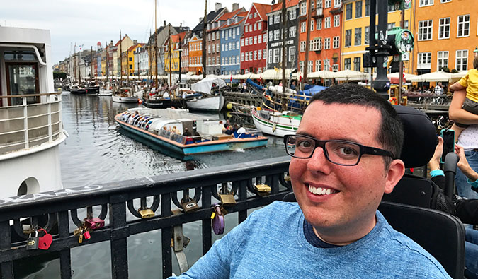 Cory Lee posing for a photo in Copenhagen near the water