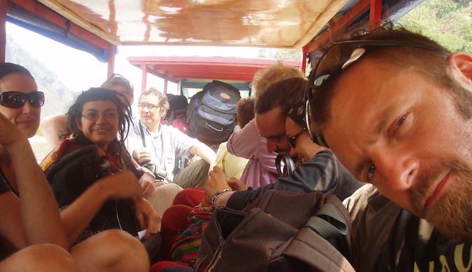 dan slater the blogger posing for a photo on a crowded bus in Asia