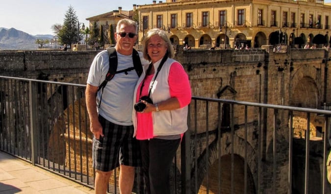 Two retired travelers posing for a photo in Europe