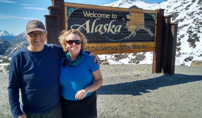Esther and her husband posing for a photo in Alaska