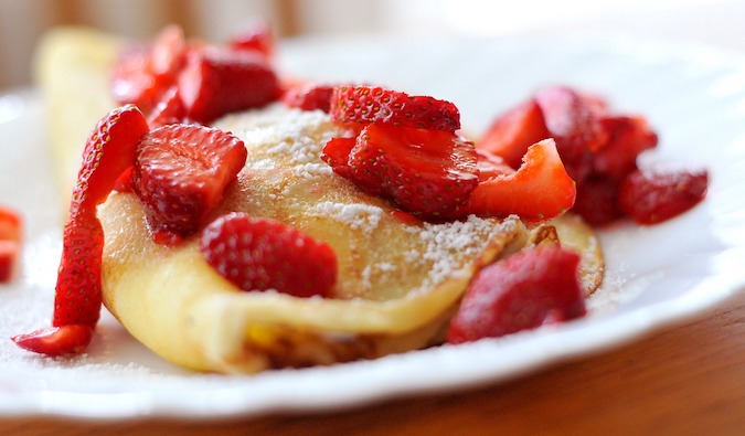 Sweet strawberry crepe with powdered sugar