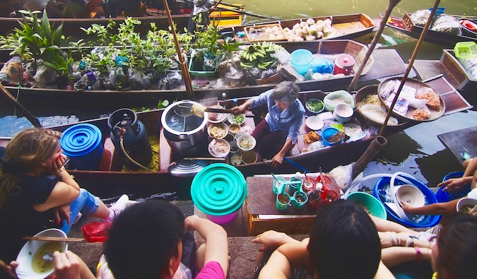 Visiting a local floating market full of small boats in Asia