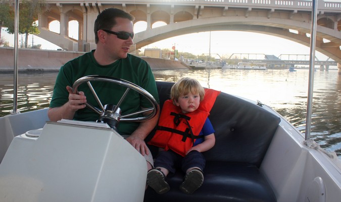 Father and son sitting in a small boat together