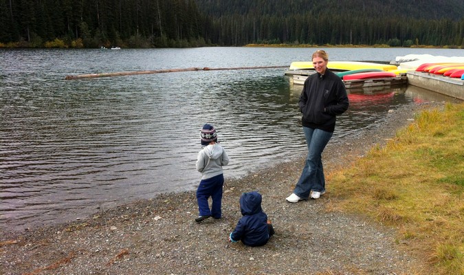 Mom and kids playing my a river on a road trip