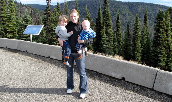 Mom holding her kids while traveling around Canada