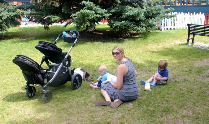 Mom and kids playing in the park during a summer family road trip