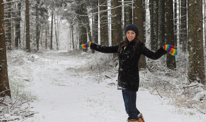Solo traveler Kristin Addis playing in the snow overseas