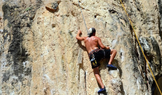 Steve Kamb, author of Level Up Your Life, rock climbing while traveling