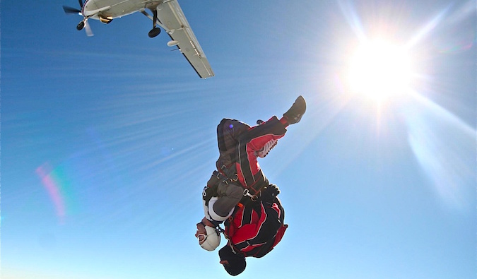 Jumping out of a plane on a skydiving adventure with a partner