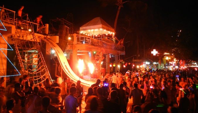 A big crowd at night at the Full Moon Party on Haat Rin beach in Thailand