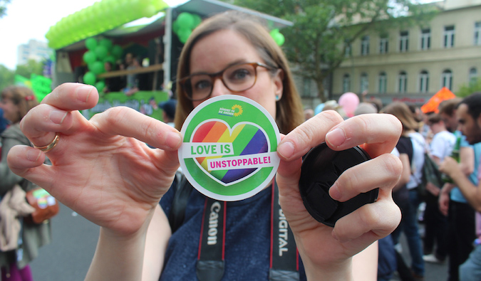 Girl holding LGBT love is unstoppable sticked at event in Berlin, Europe