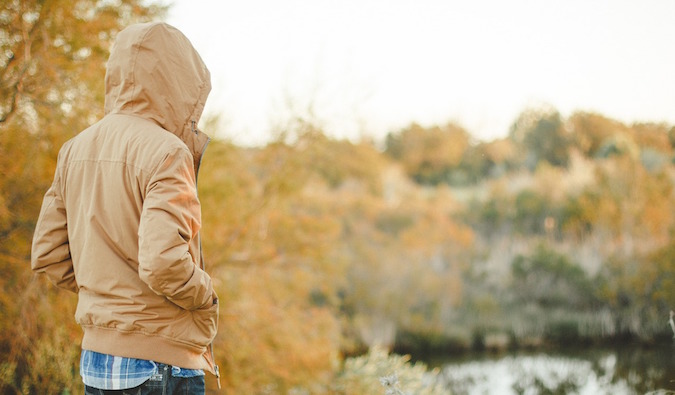 Solo male traveler in the nature overseas looking lonely