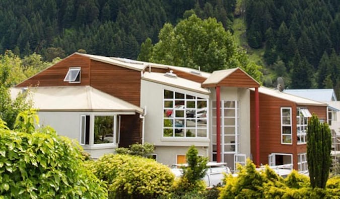 exterior of the wooden, modern-looking Haka Lodge, set against a forest in New Zealand