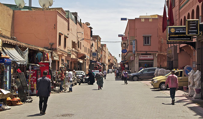 A busy street lined with stalls in sunny Morocco