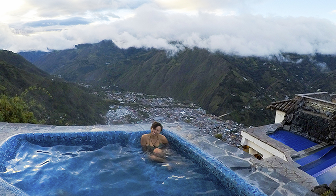 Heather, a solo female traveler, lounging in a pool in Ecuador