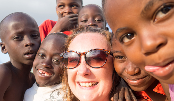 A solo female traveler volunteering in Africa with kids