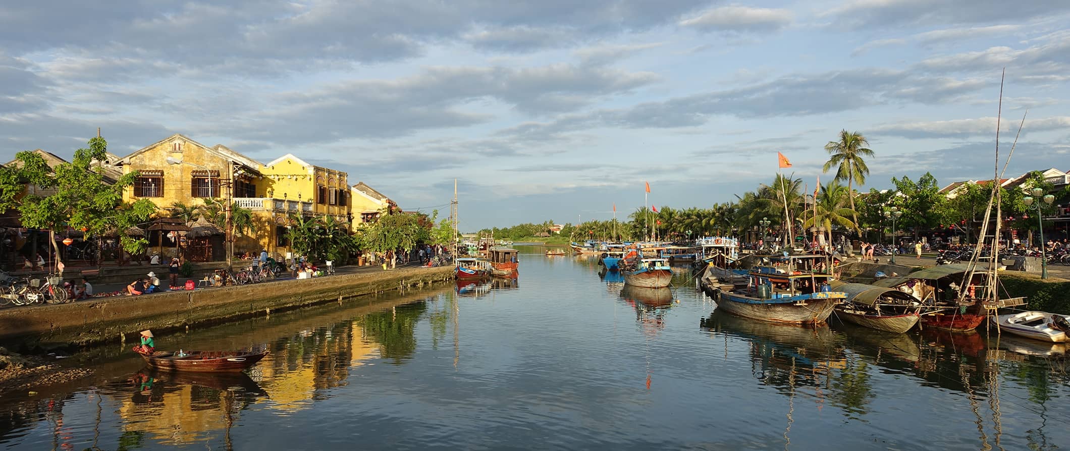 houses and boats on the water in Hoi An, Vietnam on a cloudy day