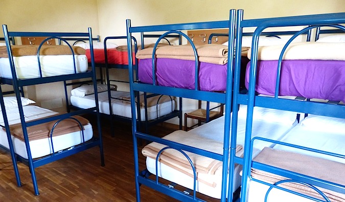 A hostel dorm full of bunk beds