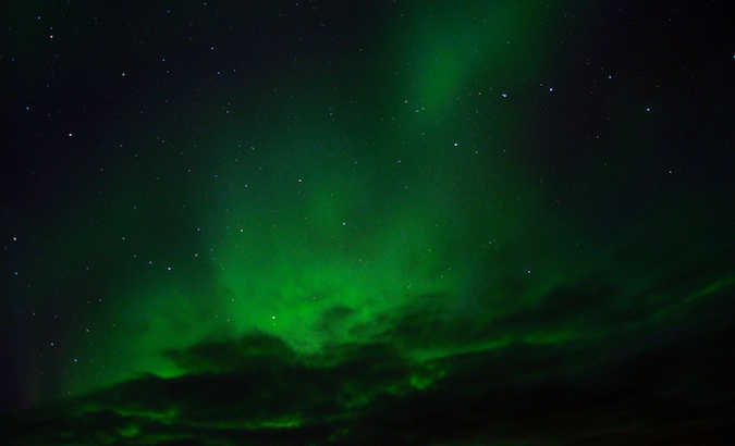 The northern lights lighting the sky up green