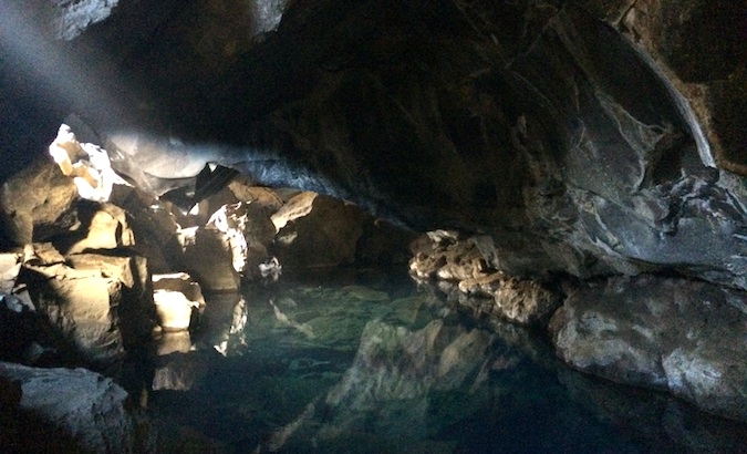 This water in the cave is warm enough to swim in and used to be a public pool for Iceland's locals