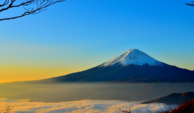 The solitary and snow-capped Mount Fuji at sunrise in Japan