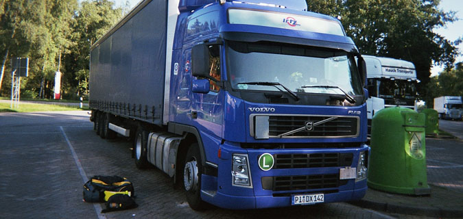 A large purple transport truck in Jordan parked in a parking lot