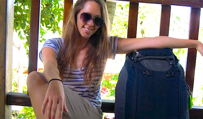 Kristin Addis, female solo travel expert, with her well-packed suitcase