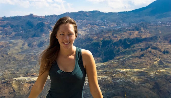 Kristen, a solo female traveler, in front of a mountain range