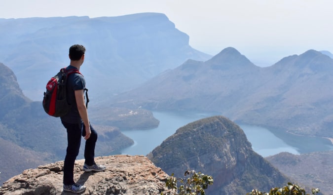 Nomadic Matt posing on the edge of the Blyde River Canyon in South Africa.