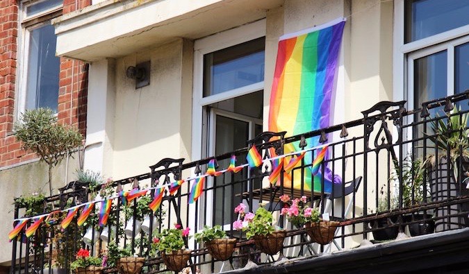 Rainbow flags hanging from a balcony for Pride