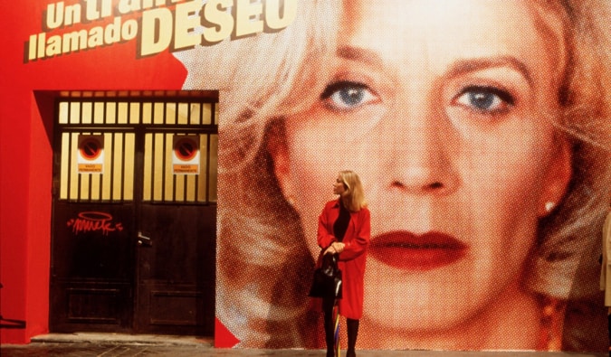 A woman standing in front of a large poster