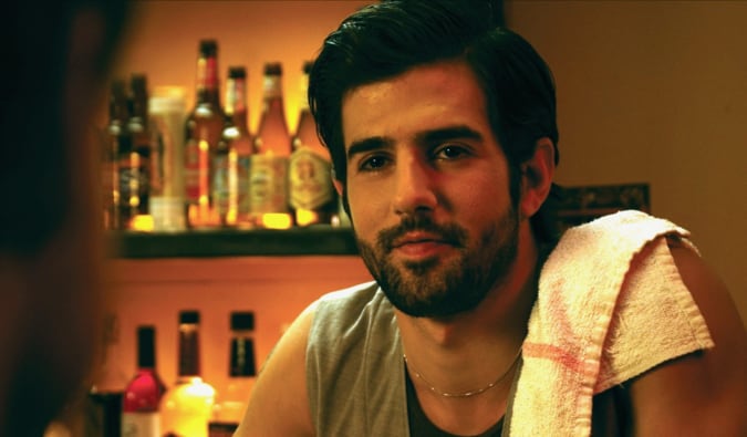 A bartender standing behind the bar