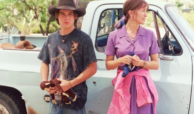 A mother and her son standing beside their truck