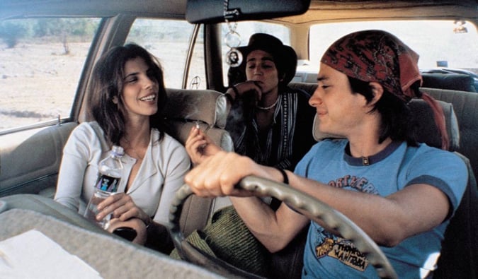 Three friends smoking in a car
