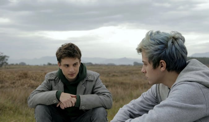 Two men talking in an empty field