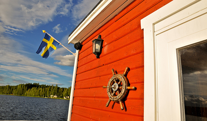 A typical Swedish cottage with a Swedish flag during the summer in Sweden