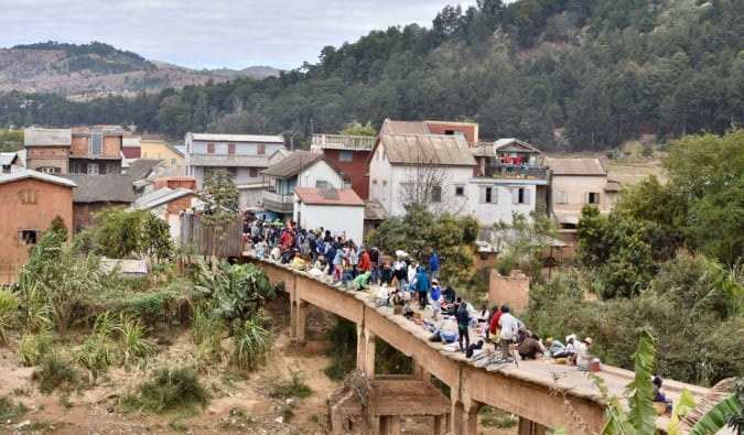 Locals crossing a narrow bridge during the day in Madagascar