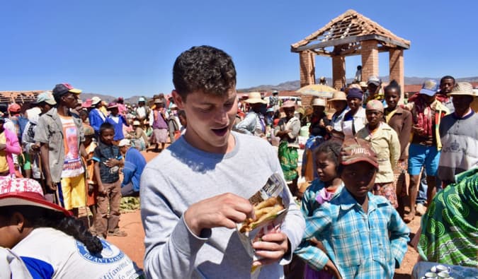 Nomadic Matt eating street food in Madagascar