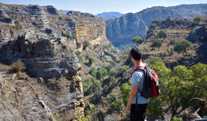 Nomadic Matt standing on a hill looking out over the landscapes of Madagascar