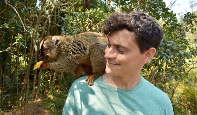 Nomadic Matt posing with a lemur on Lemur Island in Madagascar