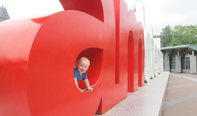 baby boy posing in the iamsterdam sign in Amsterdam, the Netherlands in Europe