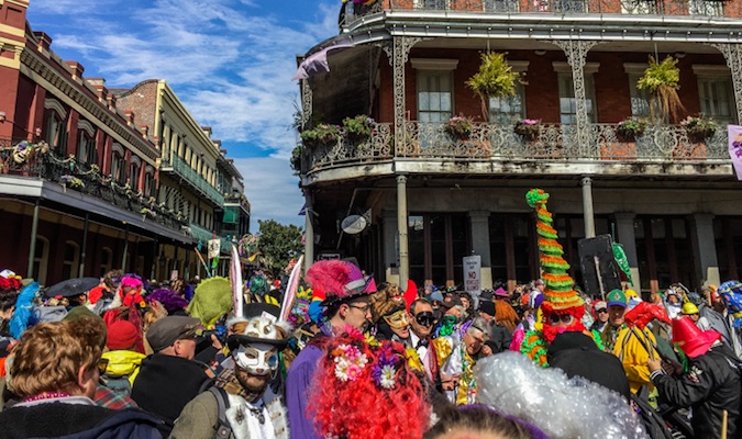 Mardi Gras attendees in costume on Bourbon Street