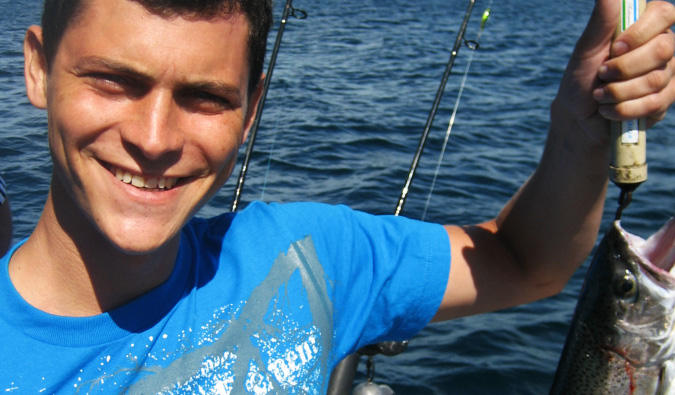 Nomadic Matt fishing in Taupo, New Zealand