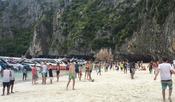 a busy and crwoded beach on koh phi phi