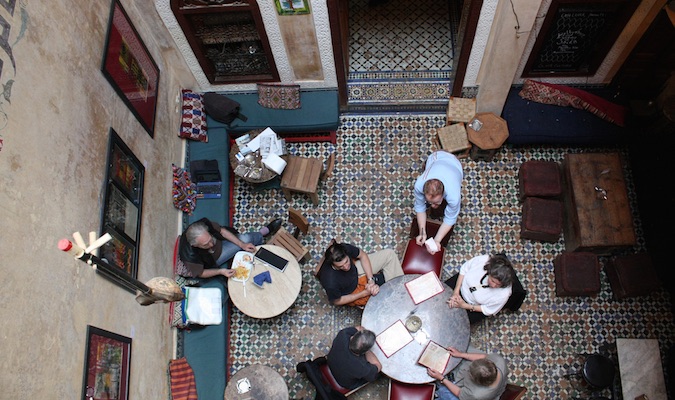 Travelers drinking tea in Cafe Clock in Fez from above