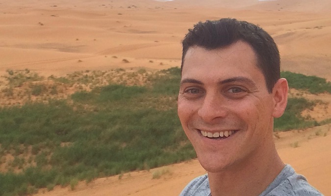 Nomadic Matt posing for a selfie in the desert of Morocco