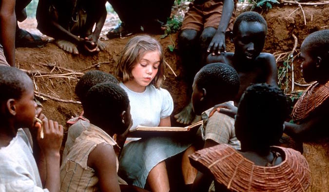 girl in nowhere in africa reading to african children